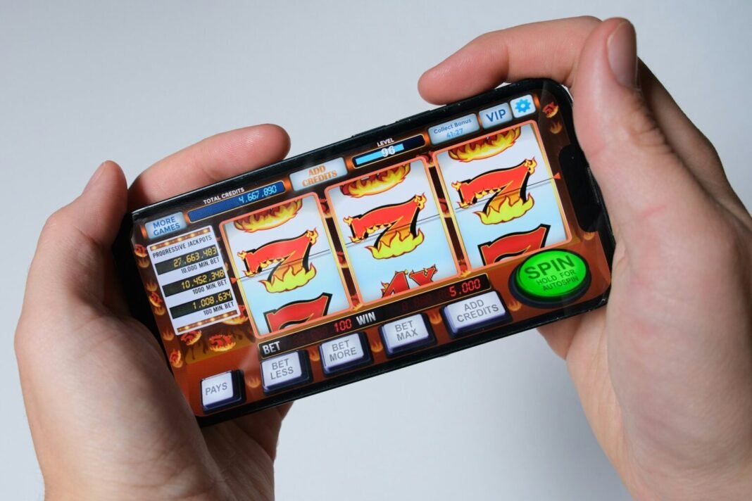 A person uses an online slot-machine game on a smartphone