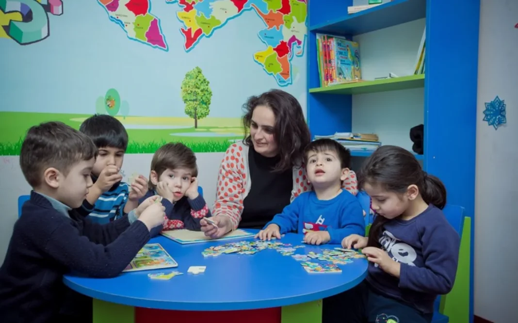 Preschool teacher leading a class with children in Azerbaijan