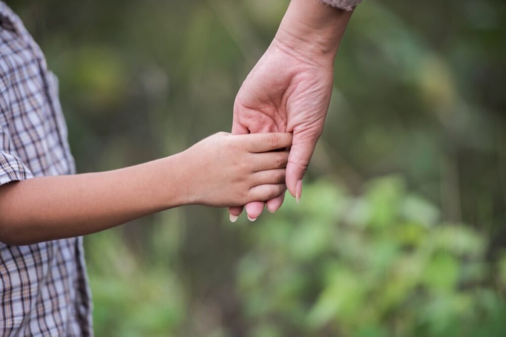 A child holding an adult's hand