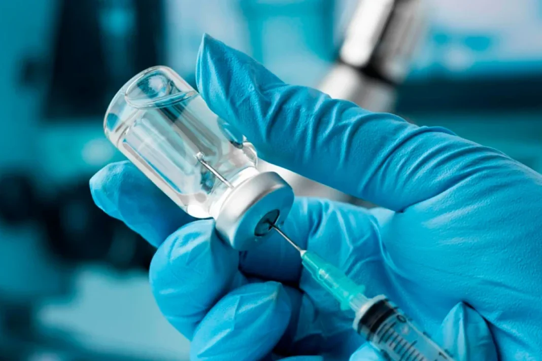 A health worker prepares a vaccine dose