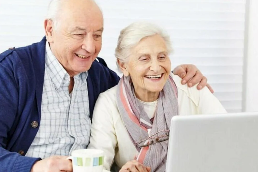 An older couple reviewing information together on a laptop