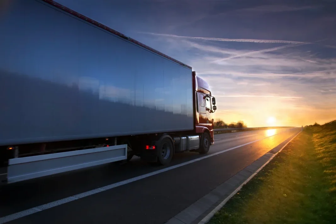 A freight truck on a highway at sunset. Illustrative photo.