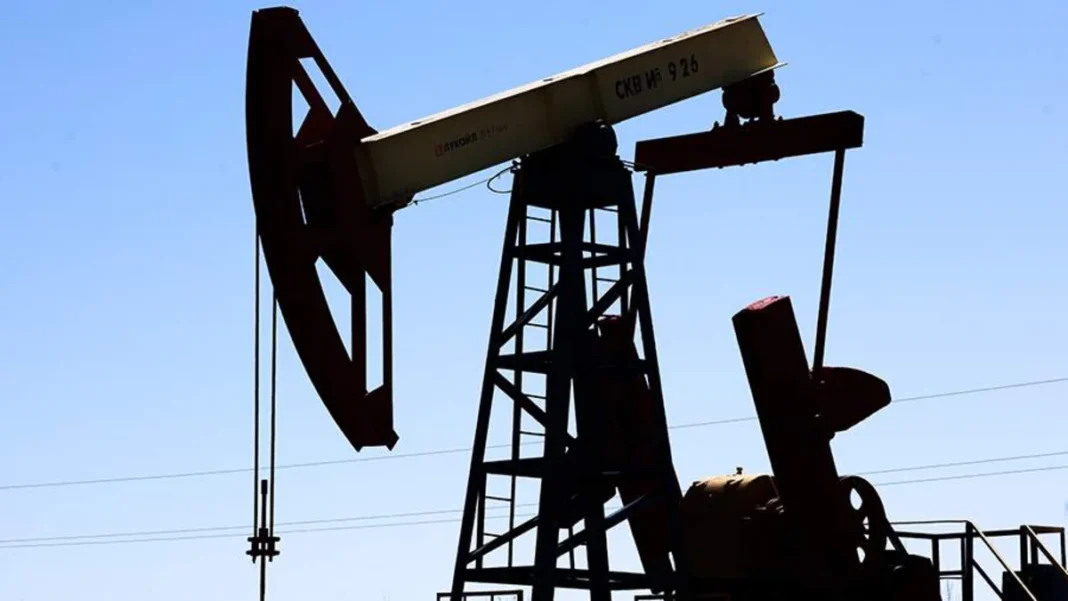 Oil pumpjack operating under a clear sky