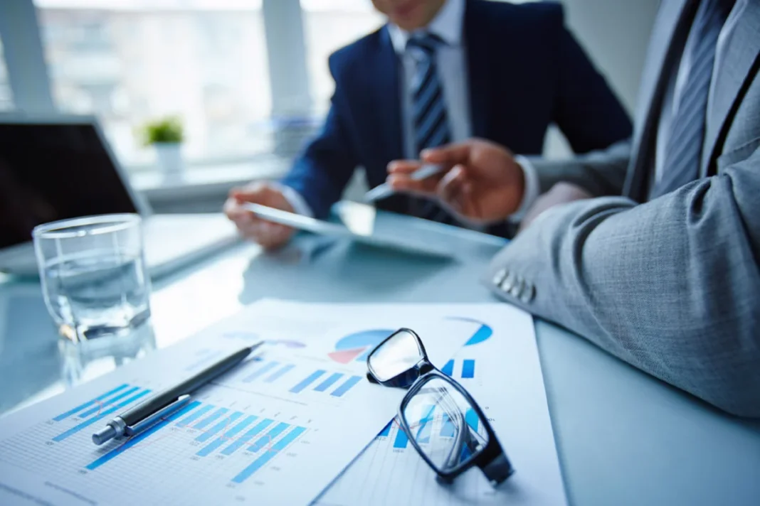 Company representatives reviewing environmental reporting documents