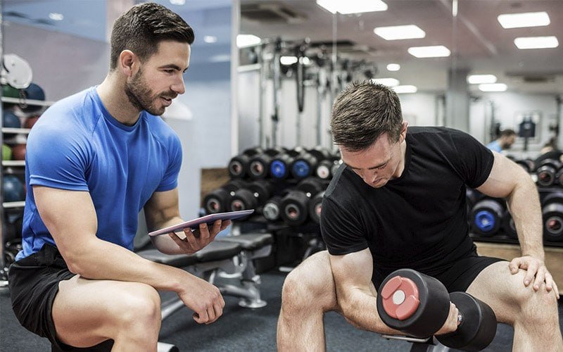 Fitness trainer working with a client in an Azerbaijan gym