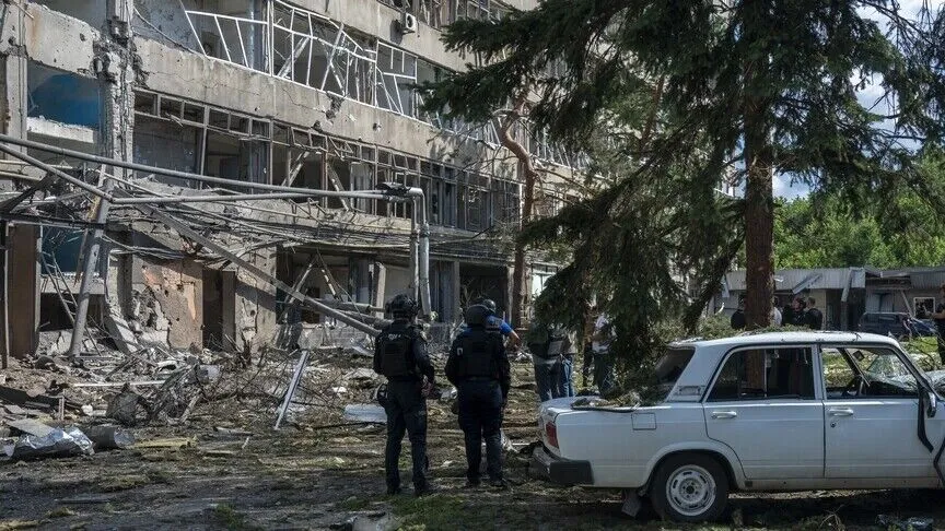 Damage to a building and vehicle after fighting in Russia’s war against Ukraine