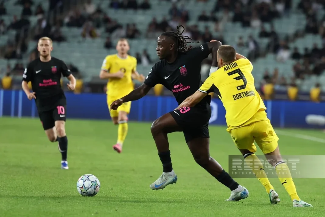 A Sabah player controls the ball under pressure from Borussia Dortmund defender Waldemar Anton during their Champions League match in Baku.